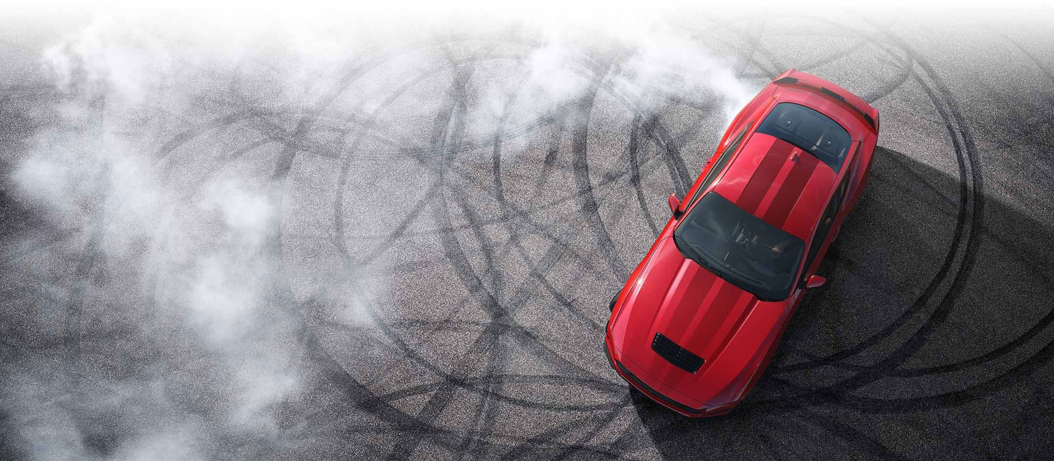 Overhead view of a 2024 Ford Mustang® model with tire tracks on pavement | Visalia Ford in Visalia CA